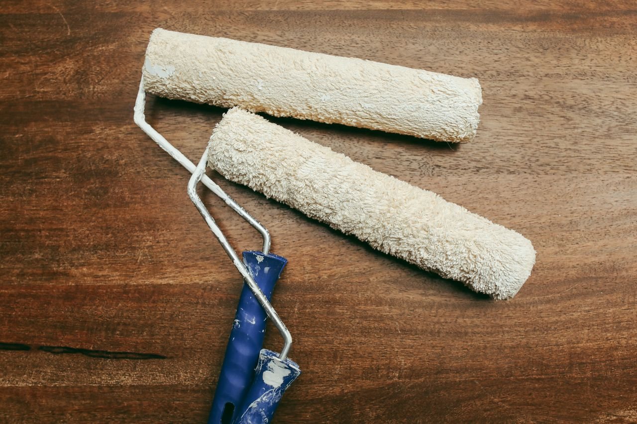 Free Two paint rollers over a wooden surface, perfect for home renovation concepts. Stock Photo